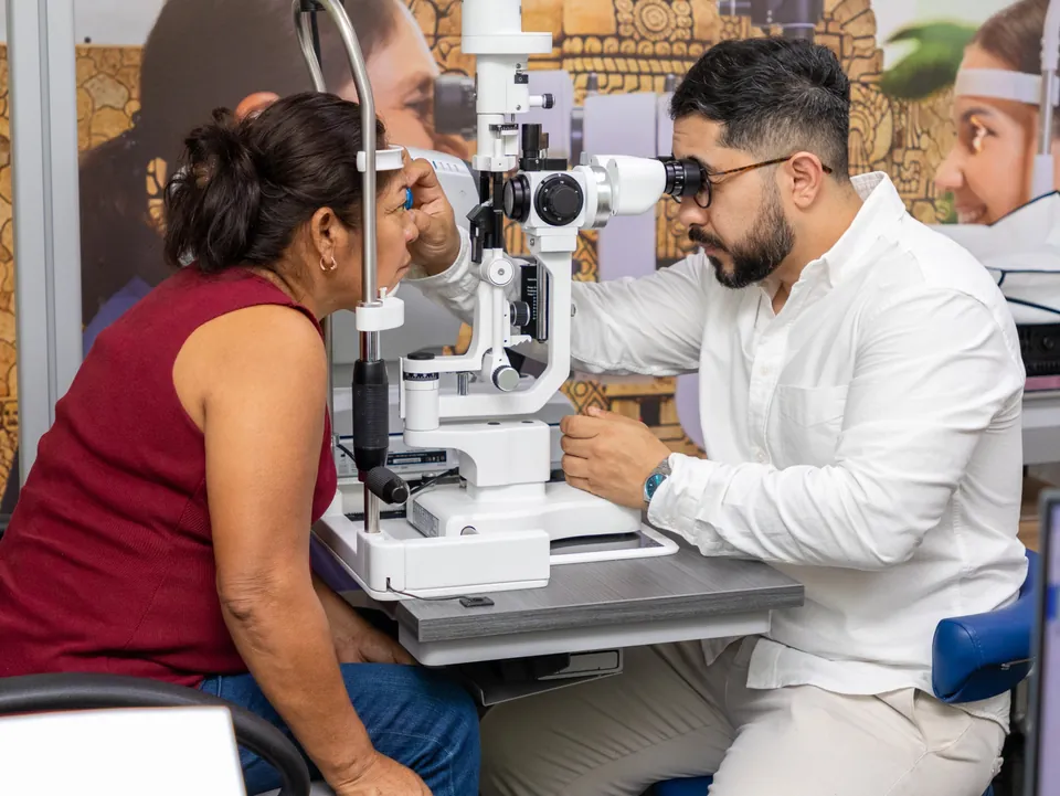 Especialista realizando una valoración oftalmológica a una paciente en la clínica de Mérida